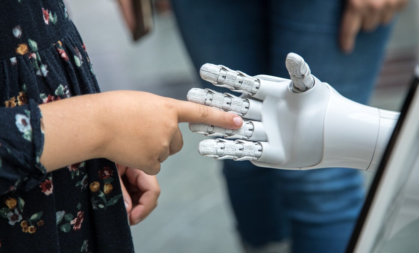 A human hand reaching towards a robotic hand