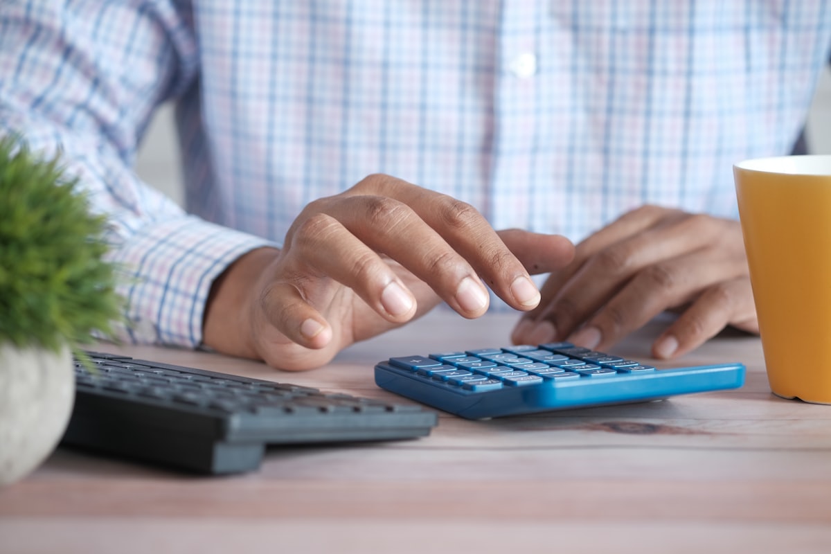 OctoPerf licensing is bounded by virtual user capacity, with usage left unrestricted Hand using a calculator to compare licensing costs